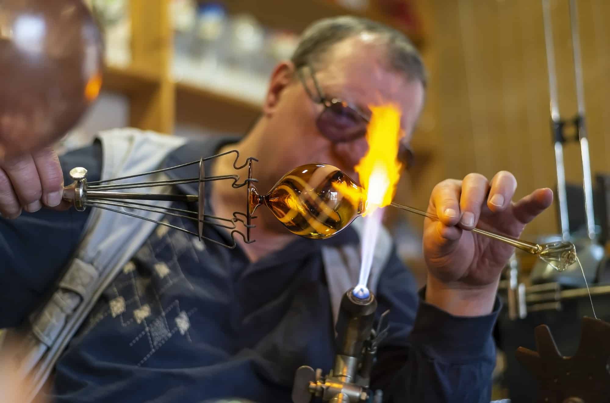 Glass blower forming melting glass