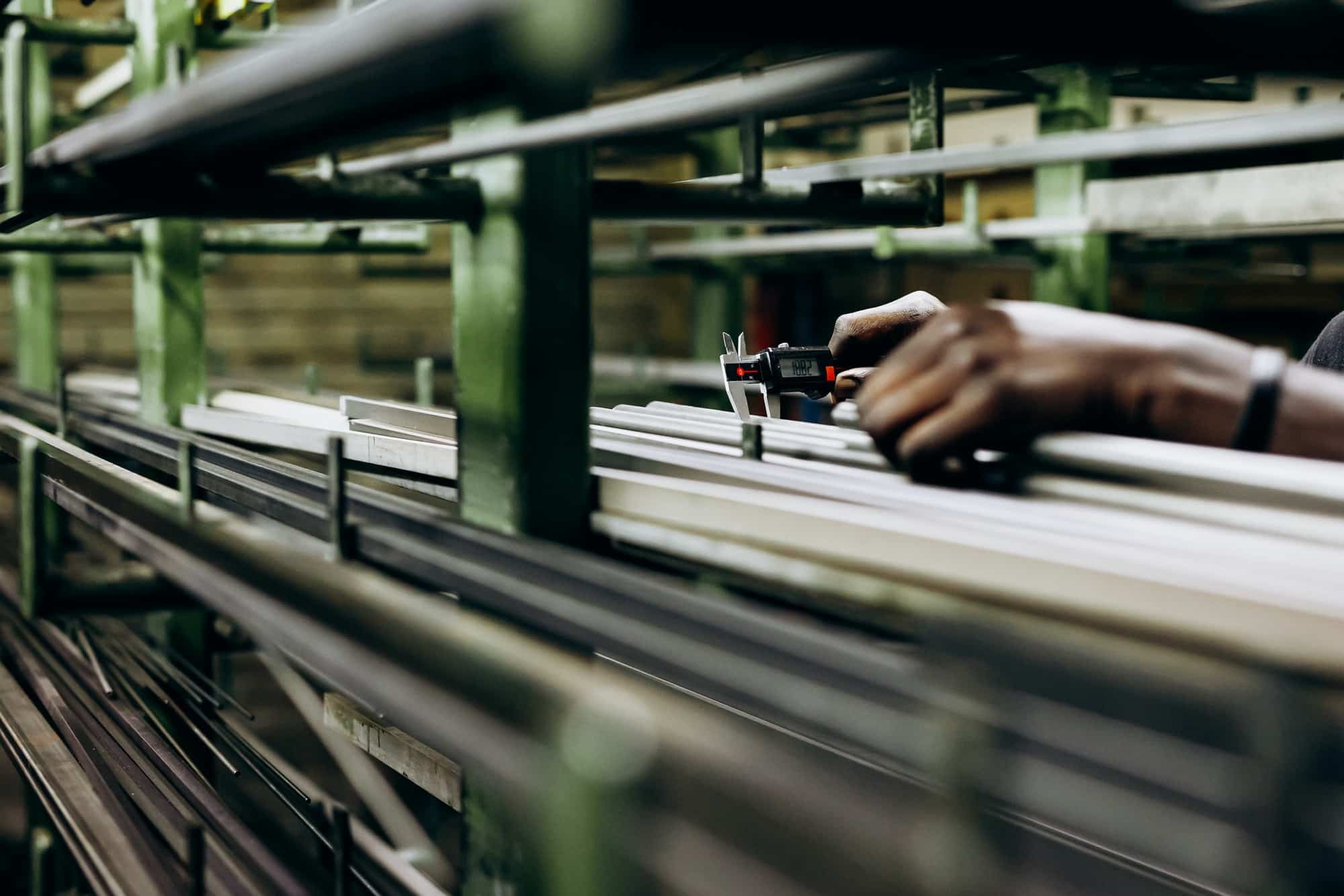 Structural aluminium pipes on shelves in building warehouse