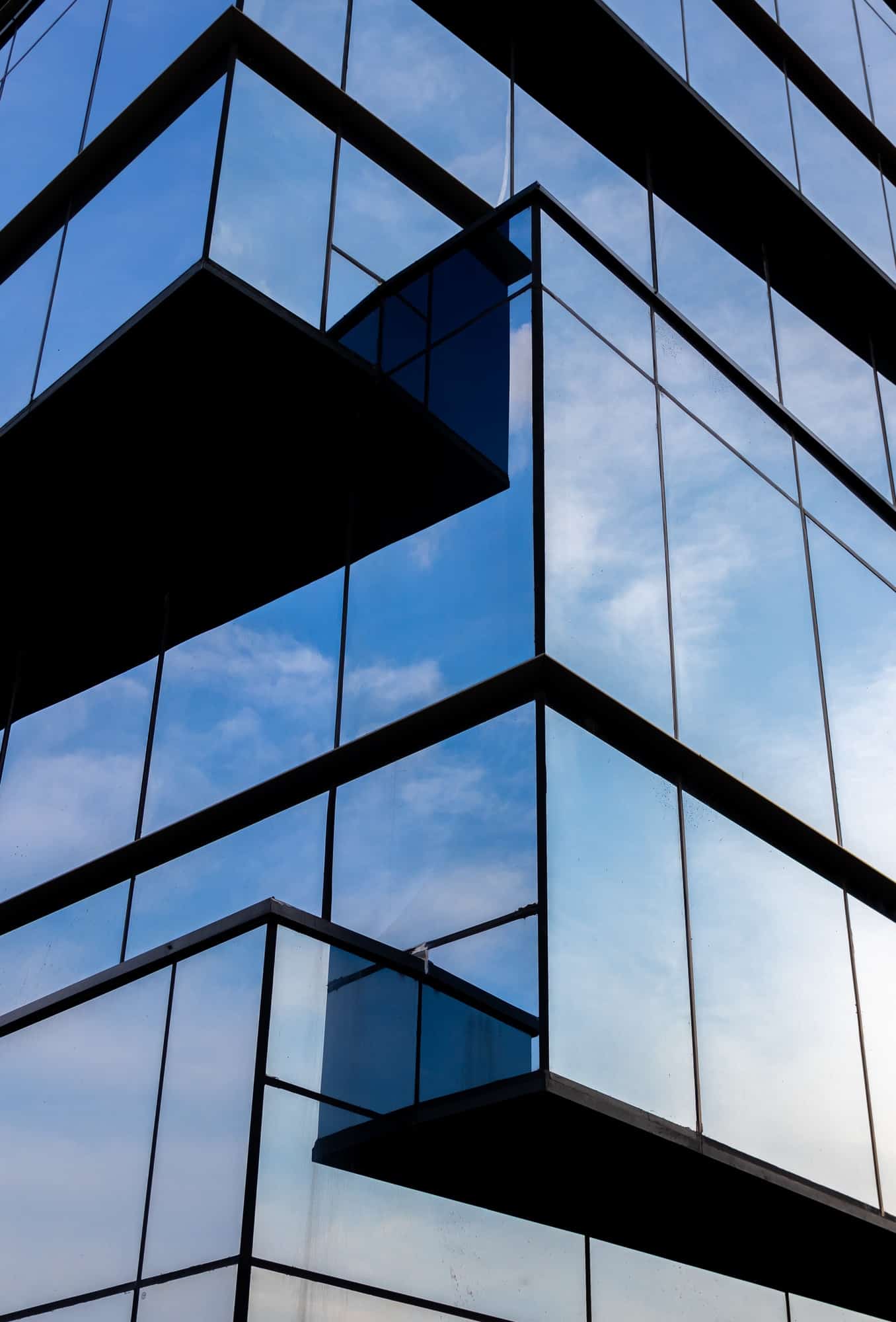 Vertical shot of a modern building in a glass facade